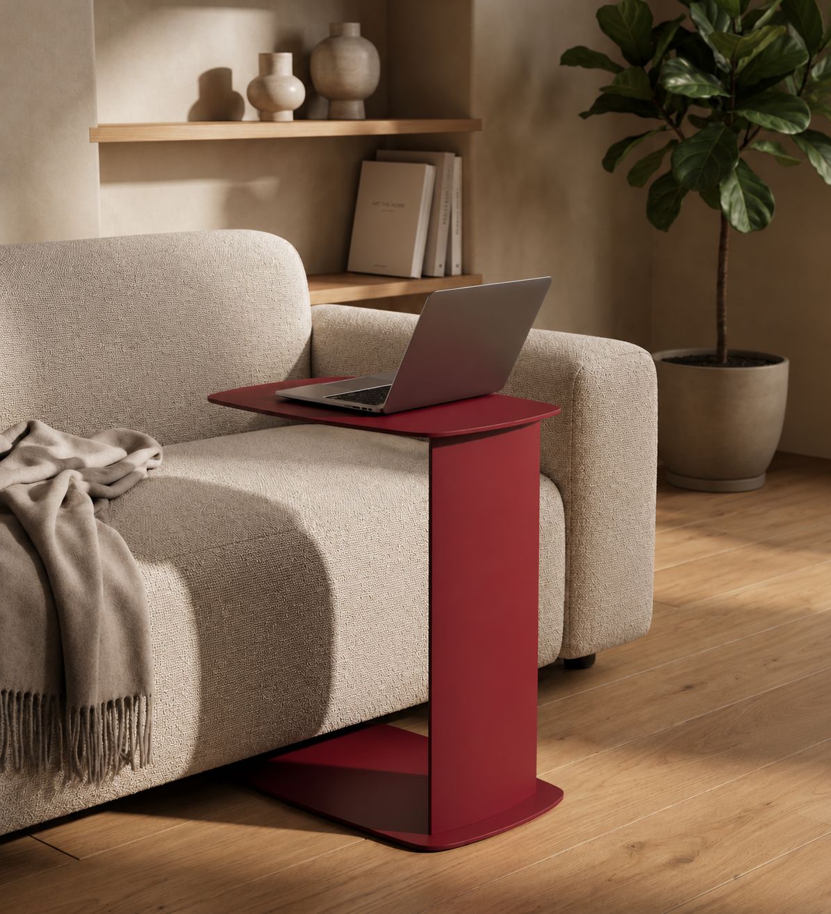 STANDBY Sofa-Beistelltisch aus Metall in C-Form mit Laptop als platzsparende Ablage direkt neben dem Sofa.