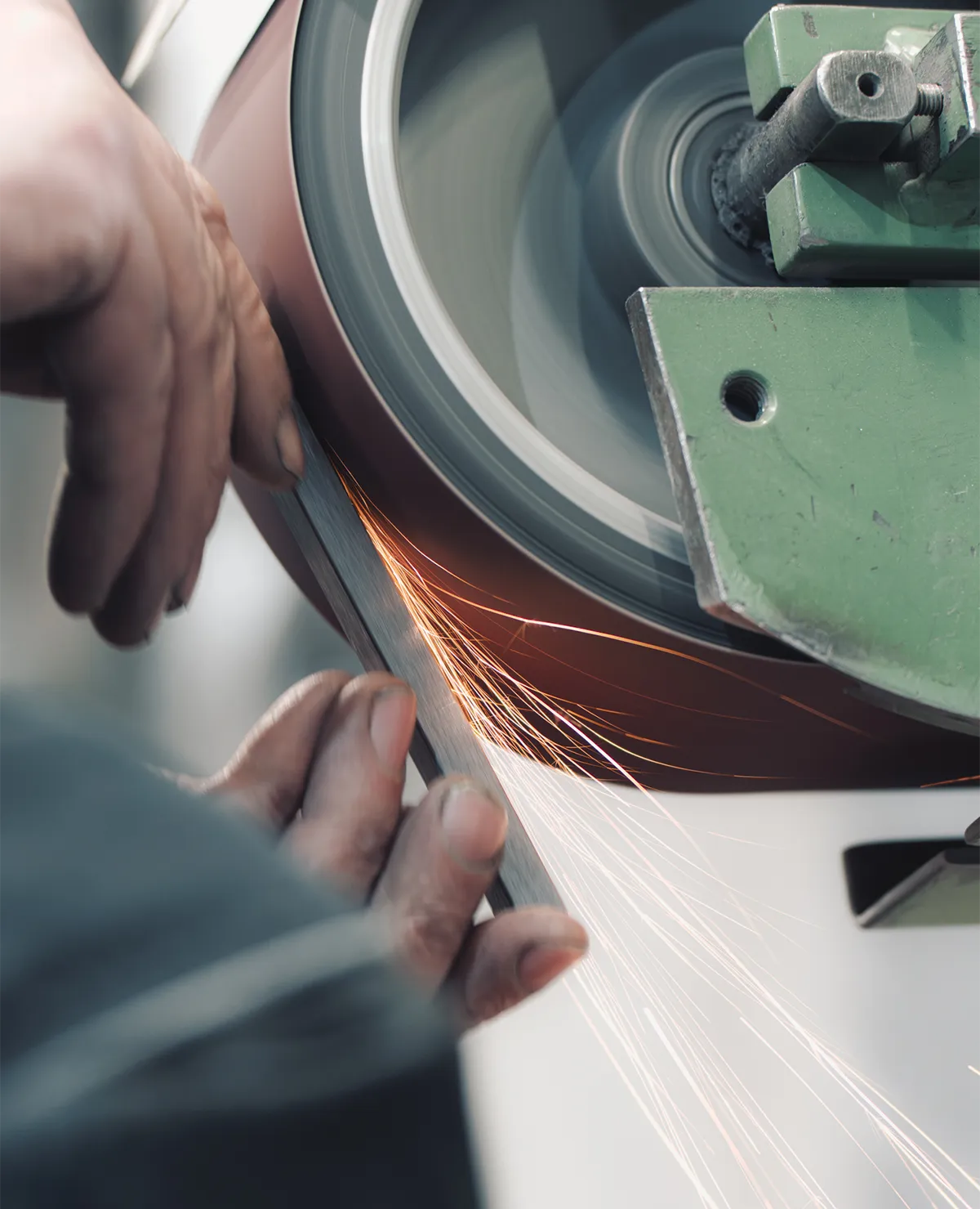 Handarbeit beim Schleifen von Metalloberflächen in der Manufaktur von Siqual Design